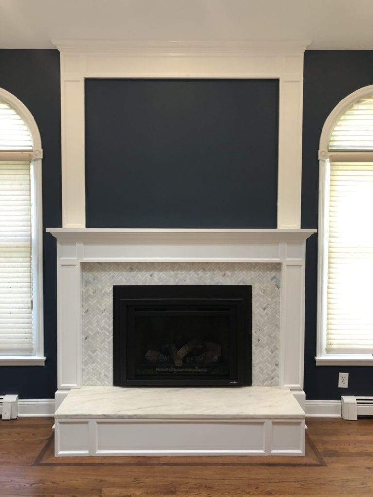 Heat N Glo Escape gas fireplace insert with white mantel