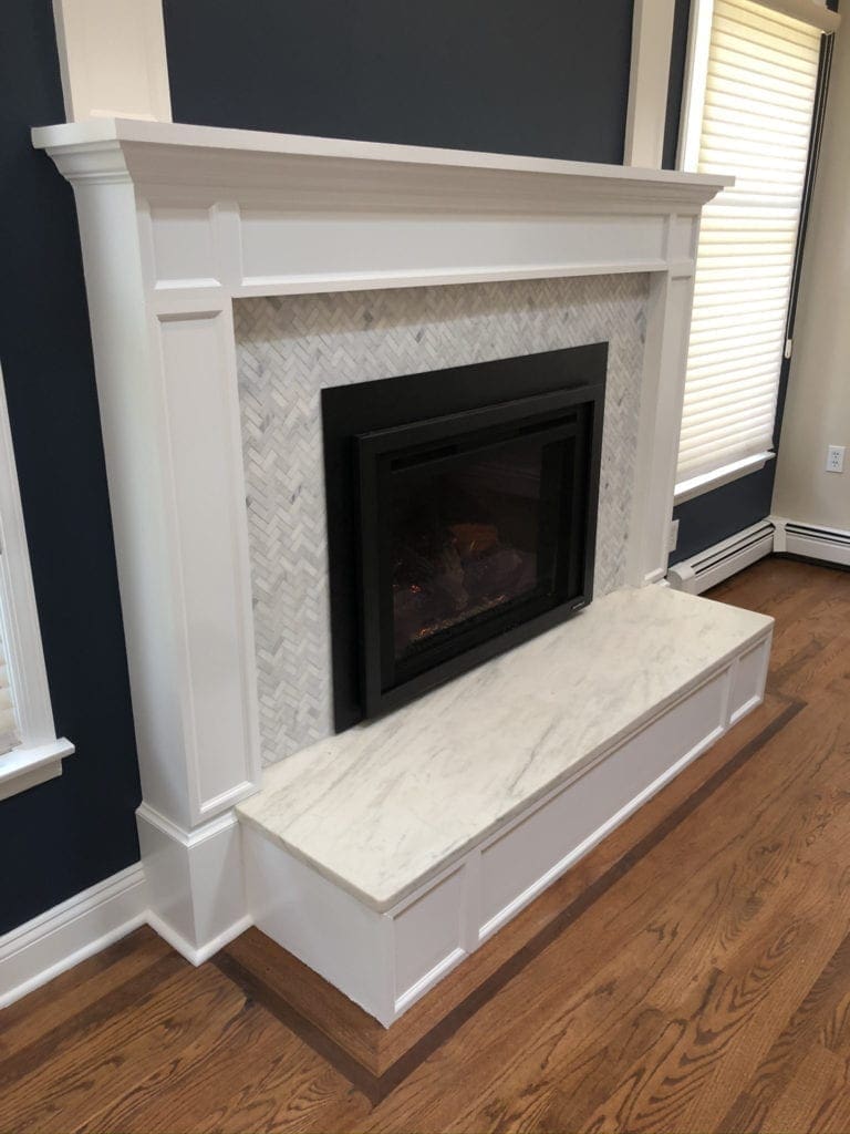 Heat N Glo Escape gas fireplace insert with white mantel
